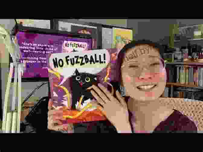 Isabella Kung, Author Of No Fuzzball, Smiling And Holding A Copy Of Her Book No Fuzzball Isabella Kung